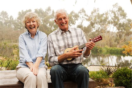 senior adult relaxing portrait not child - Husband playing the ukelele with wife by lake Stock Photo - Premium Royalty-Free, Code: 614-07234956