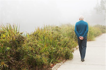 Senior man strolling in the park Stock Photo - Premium Royalty-Free, Code: 614-07234957