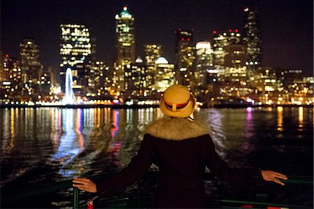 Woman and Seattle skyline at night, Washington, USA Stock Photo - Premium Royalty-Free, Code: 614-07239931