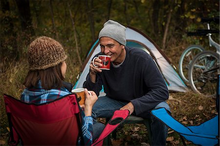 simsearch:614-07239972,k - Mature couple sitting on camping chairs outside tent, drinking hot drinks Stock Photo - Premium Royalty-Free, Code: 614-07239977