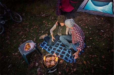 fire escape - Mature couple sitting outside tent with barbecue and glass of wine Stock Photo - Premium Royalty-Free, Code: 614-07239985