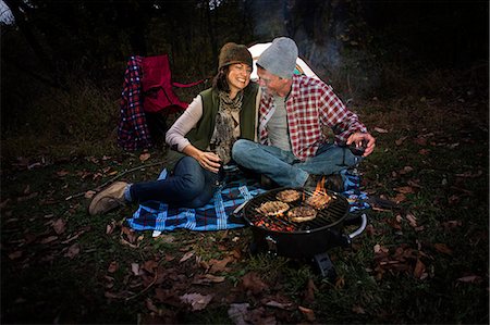 simsearch:614-07239972,k - Mature couple sitting outside tent with barbecue and glass of wine Stock Photo - Premium Royalty-Free, Code: 614-07239986
