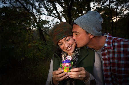 simsearch:614-07239972,k - Mature couple outside tent holding birthday cupcake Stock Photo - Premium Royalty-Free, Code: 614-07239989