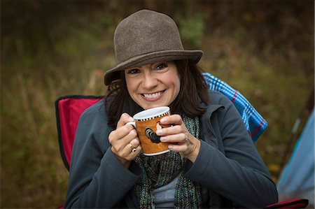 simsearch:614-07239972,k - Mature woman sitting on camping chair, drinking hot drink Stock Photo - Premium Royalty-Free, Code: 614-07239980