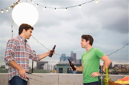 electric light - Two male adult friends chatting at rooftop barbecue Stock Photo - Premium Royalty-Free, Code: 614-07240196