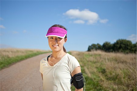 Portrait of young female runner on dirt track Stock Photo - Premium Royalty-Free, Code: 614-07444006