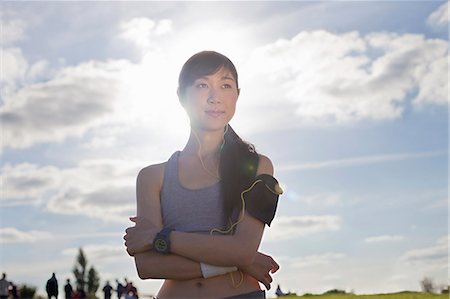 Portrait of young female runner with arms folded Stock Photo - Premium Royalty-Free, Code: 614-07444024