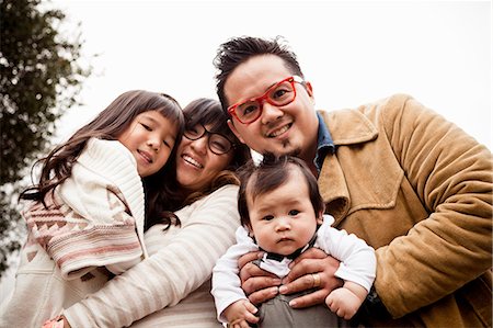 family portrait asian not grandparent - Family portrait of mid adult couple with daughter and baby boy in park Stock Photo - Premium Royalty-Free, Code: 614-07444065