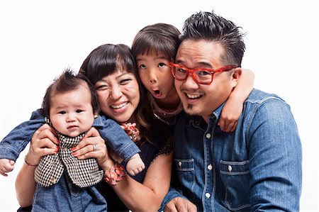 family portrait asian not grandparent - Studio portrait of mid adult couple with daughter and baby boy Stock Photo - Premium Royalty-Free, Code: 614-07444073