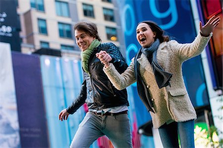 fun winter people - Young couple running on street, New York City, USA Stock Photo - Premium Royalty-Free, Code: 614-07444083