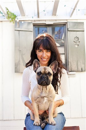 Portrait of young woman holding dog Stock Photo - Premium Royalty-Free, Code: 614-07444225