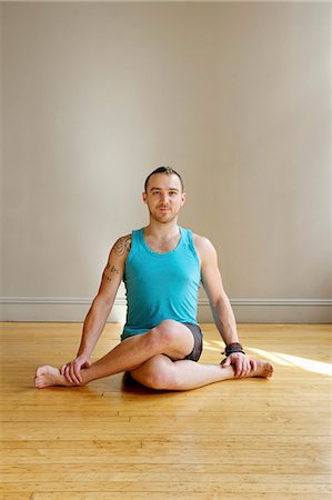 Man in Cowface yoga pose Stock Photo - Premium Royalty-Free, Code: 614-07444344