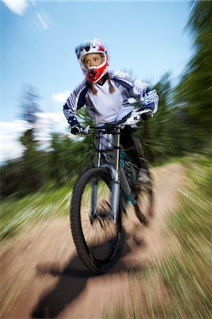 simsearch:614-06624830,k - Female mountain biker speeding downhill Stock Photo - Premium Royalty-Free, Code: 614-07444373
