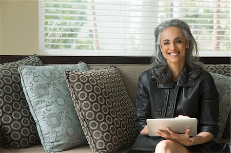 single mature people - Woman using digital tablet on sofa Stock Photo - Premium Royalty-Free, Code: 614-07453267