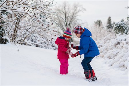simsearch:614-07806393,k - Brother showing icicles to sister whilst out in snow Stock Photo - Premium Royalty-Free, Code: 614-07486900