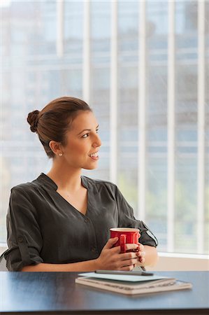 simsearch:649-07119200,k - Young businesswoman having a coffee break in office Stock Photo - Premium Royalty-Free, Code: 614-07487003