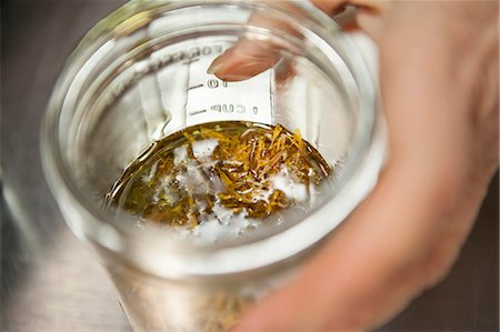 Making a remedy with calendula and olive oil in health foods store Stock Photo - Premium Royalty-Free, Code: 614-07487212