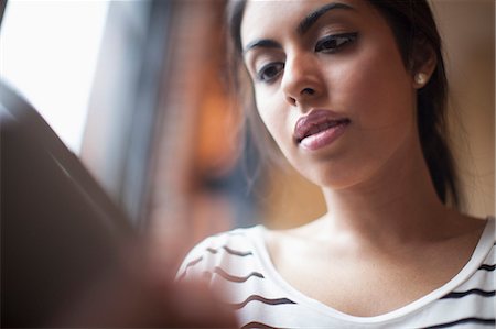 Young woman using laptop computer Stock Photo - Premium Royalty-Free, Code: 614-07487273