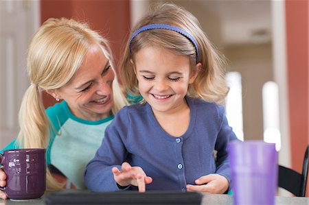 pigtails - Mother and young daughter with digital tablet Stock Photo - Premium Royalty-Free, Code: 614-07587657