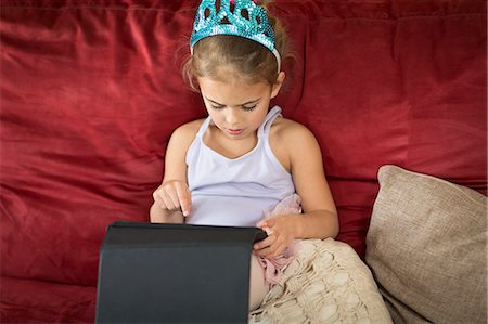 fingers holding - Young girl using touchscreen on digital tablet Stock Photo - Premium Royalty-Free, Code: 614-07587669