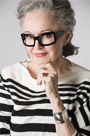 senior woman glasses - Portrait of senior woman, hand on chin Stock Photo - Premium Royalty-Free, Code: 614-07587683