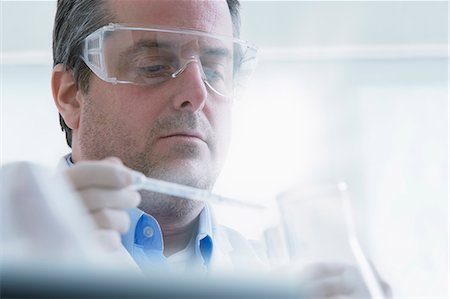science lab - Scientist holding dropper and test tube Stock Photo - Premium Royalty-Free, Code: 614-07652259
