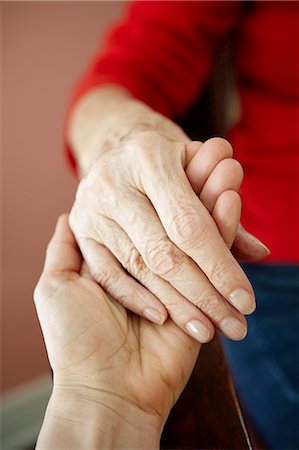 Close up of mature woman holding 82 year old grandmothers hand Stock Photo - Premium Royalty-Free, Code: 614-07652268