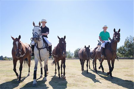 Polo players, leading horses in from field Stock Photo - Premium Royalty-Free, Code: 614-07708245