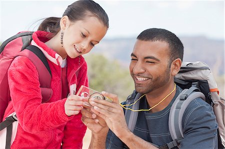 Father and daughter looking at compass whilst out hiking, Sedona, Arizona, USA Stock Photo - Premium Royalty-Free, Code: 614-07708323