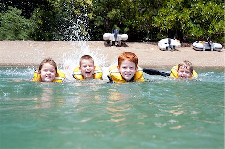 simsearch:649-07520254,k - Brothers and sister in a row swimming in sea Stock Photo - Premium Royalty-Free, Code: 614-07735214