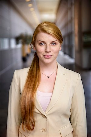 Portrait of confident young businesswoman in office corridor Stock Photo - Premium Royalty-Free, Code: 614-07735228
