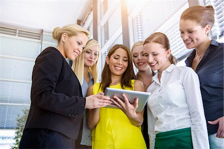 simsearch:649-07736470,k - Six female businesswomen looking down at digital tablet in office Stock Photo - Premium Royalty-Free, Code: 614-07735346