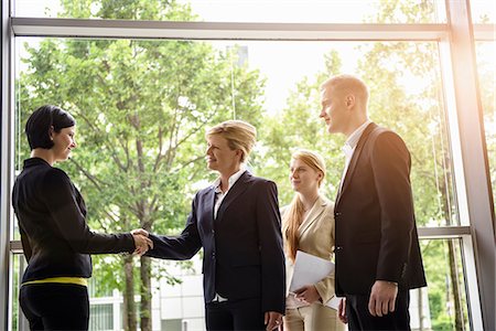 simsearch:649-07736470,k - Businesswomen and men greeting client in office Stock Photo - Premium Royalty-Free, Code: 614-07735356