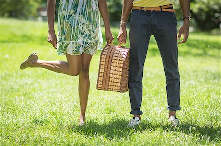 Cropped image of young couple with picnic basket in park Stock Photo - Premium Royalty-Free, Code: 614-07735391