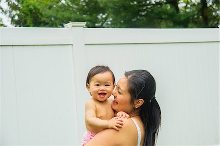 Portrait of mid adult mother and baby boy in garden Stock Photo - Premium Royalty-Free, Code: 614-07735518