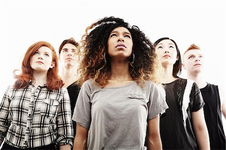 Low angle studio portrait of five young adults looking upward Stock Photo - Premium Royalty-Free, Code: 614-07735556