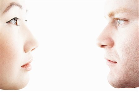 portrait white - Close up studio portrait of young couple face to face in profile Stock Photo - Premium Royalty-Free, Code: 614-07735603