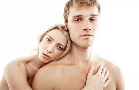 female smirk - Studio portrait of bare chested young couple staring Stock Photo - Premium Royalty-Free, Code: 614-07768188