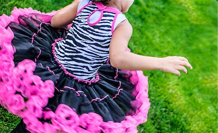 simsearch:614-06442834,k - Cropped rear view of girl running in frilly party dress Photographie de stock - Premium Libres de Droits, Code: 614-07805732