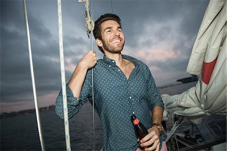 Mid adult man with beer on sailing boat, portrait Stock Photo - Premium Royalty-Free, Code: 614-07805987