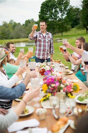 raised - Family and friends making a toast at outdoor meal Stock Photo - Premium Royalty-Free, Code: 614-07806389