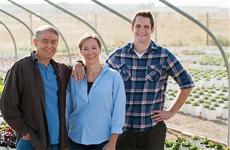 portrait man shirt shop - Portrait of three workers in plant nursery polytunnel Stock Photo - Premium Royalty-Free, Code: 614-07806406