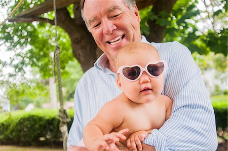 funny baby - Portrait of grandfather and baby granddaughter in heart shaped sunglasses Stock Photo - Premium Royalty-Free, Code: 614-07911722