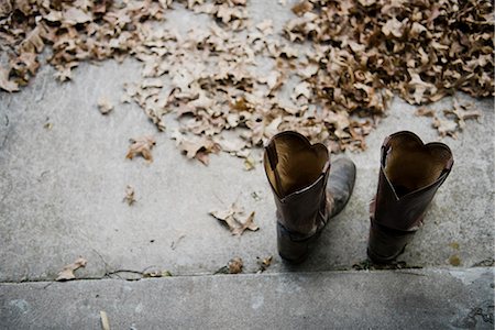 High angle view of a pair of cowboy boots on step Stock Photo - Premium Royalty-Free, Code: 614-07911863