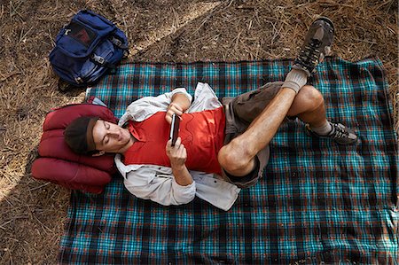 full body cell - Overhead view of young male camper lying on picnic blanket in forest, Los Angeles, California, USA Stock Photo - Premium Royalty-Free, Code: 614-08000202