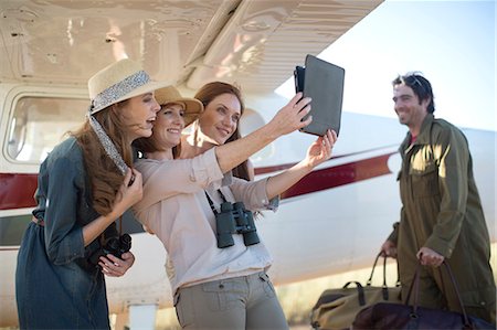 Tourists taking selfie with digital tablet beside plane, Wellington, Western Cape, South Africa Stock Photo - Premium Royalty-Free, Code: 614-08030946