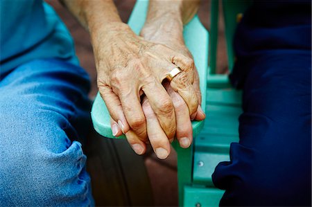 Cropped close up of senior couple hands holding on park bench Stock Photo - Premium Royalty-Free, Code: 614-08031084