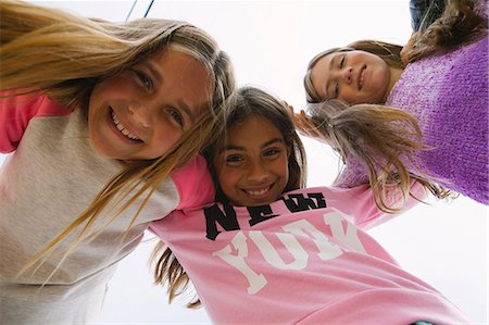 simsearch:614-03469543,k - Three girls with arms round each other, low angle Stock Photo - Premium Royalty-Free, Code: 614-08031140