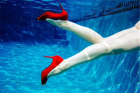 simsearch:614-08065889,k - Mature woman, nude, wearing only red high heels, underwater view, low section Stock Photo - Premium Royalty-Free, Code: 614-08065892