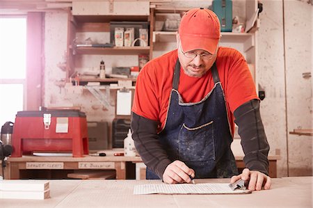 simsearch:649-07710266,k - Cabinet maker checking blueprint at workshop bench Stock Photo - Premium Royalty-Free, Code: 614-08065906